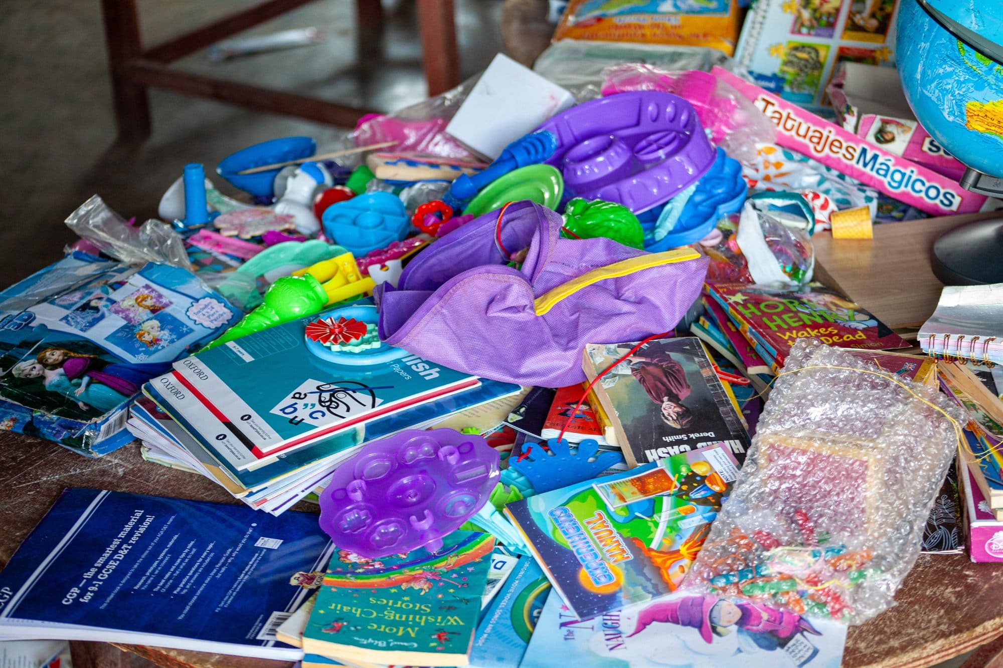 Donated toys, books and stationery laid out ready for distribution