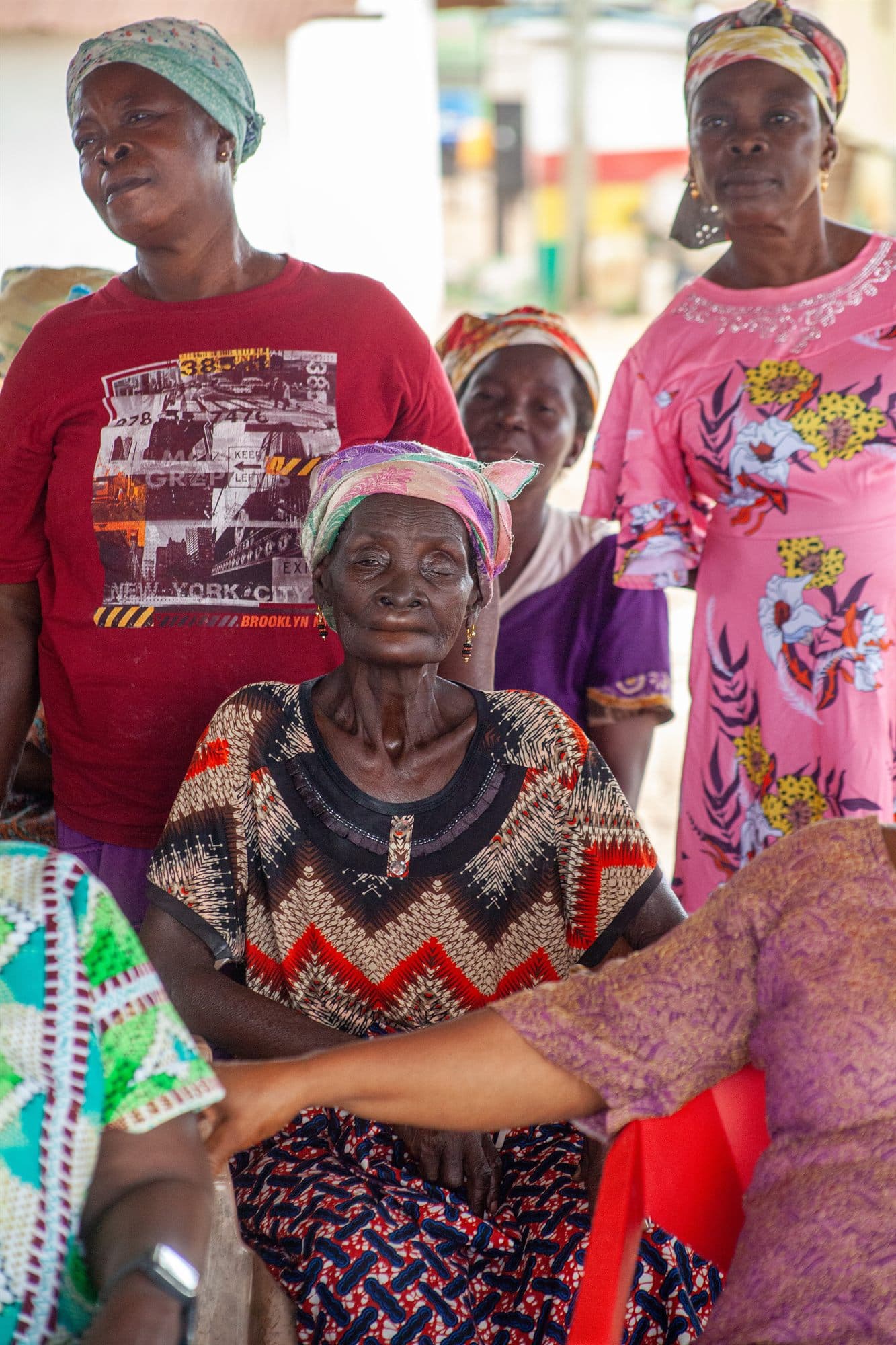 Community elders in colourful dress gathered together at an outreach