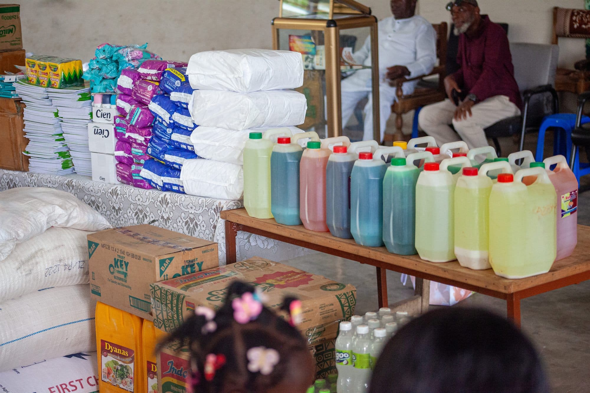Donated food, toiletries and school supplies laid out for a distribution day
