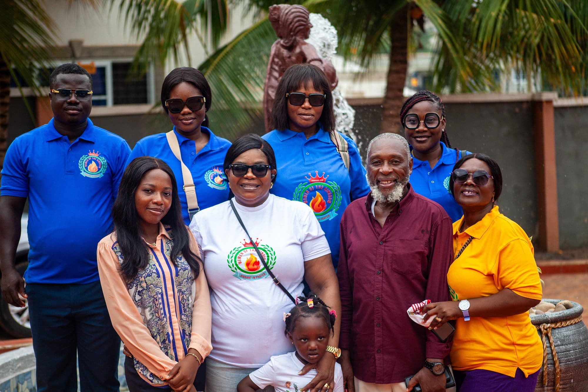 Women of the Kingdom team members and community members gathered together and smiling at an outreach gathering